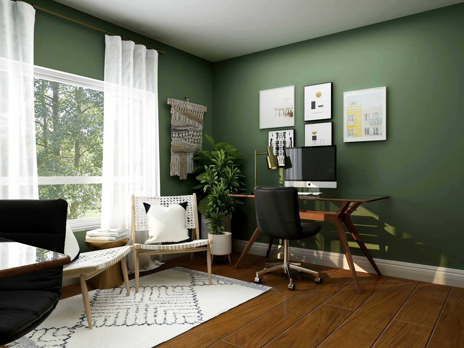 Home office with deep green walls and natural light